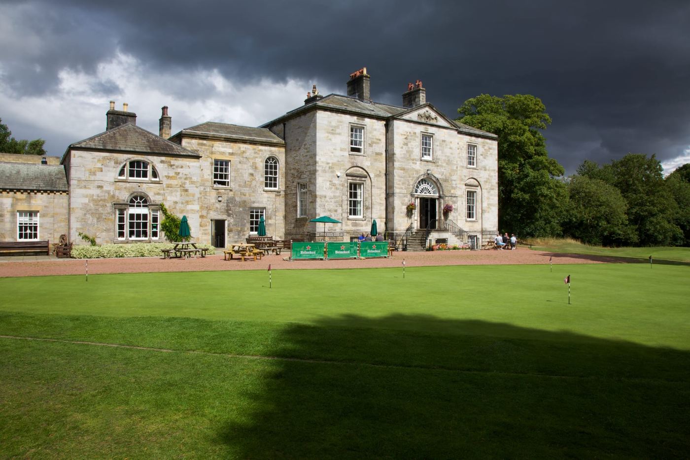 The historic clubhouse at Hexham Golf Club, with the practice putting green in front