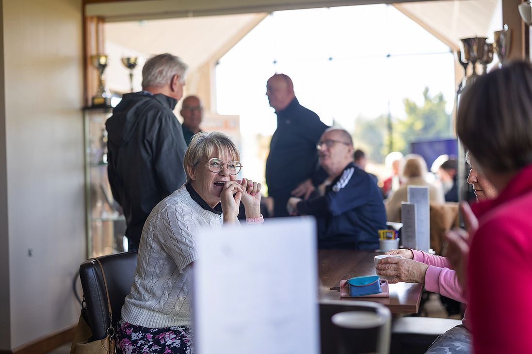 Guests laughing together over coffee