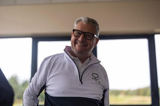 Andrew Biggs, co-founder of Stroke Play Golf, smiling in the clubhouse